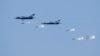 FILE - Myanmar Air Force fighter jets drop bombs during exercises Feb. 2, 2018, in Myanmar's Ayeyarwaddy delta region. In a report released Nov. 3, 2022, Amnesty International is urging suppliers of aviation fuel to Myanmar's military government to suspen