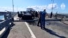 Investigators work on the automobile span of the Crimean Bridge connecting Russian mainland with Crimea after traffic on the bridge was halted July 17, 2023, after reports of explosions. (Investigative Committee of Russia via AP)