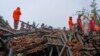 Rescuers work at a site of a landslide triggered by torrential rains in Raigad, western Maharashtra state, India, July 20, 2023.