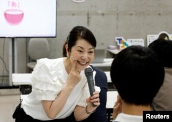 Smile coach Keiko Kawano teaches students at a smile training course at Sokei Art School in Tokyo, Japan, May 30, 2023. REUTERS/Kim Kyung-Hoon REFILE