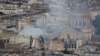 Smoke rises above rooftops following a gas explosion in the 5th arrondissement of Paris, France, June 21, 2023.