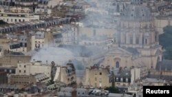 Smoke rises above rooftops following a gas explosion in the 5th arrondissement of Paris, France, June 21, 2023.