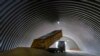 FILE - A truck unloads grain in the village of Zghurivka, Ukraine, Aug. 9, 2022. 