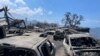 In this photo provided by Tiffany Kidder Winn, burned-out cars sit after a wildfire raged through Lahaina, Hawaii, on Aug. 9, 2023. 