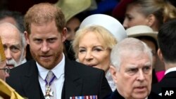 Britain's Prince Harry, Duke of Sussex, and Prince Andrew leave Westminster Abbey following the coronation of Britain's King Charles and Queen Camilla, in London, May 6, 2023.