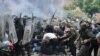 NATO Kosovo Force (KFOR) soldiers clash with local Kosovo Serb protesters at the entrance of the municipality office, in the town of Zvecan, Kosovo, May 29, 2023.