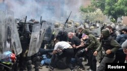 NATO Kosovo Force (KFOR) soldiers clash with local Kosovo Serb protesters at the entrance of the municipality office, in the town of Zvecan, Kosovo, May 29, 2023.