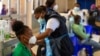 A professional paramedic receives a dose of Johnson & Johnson COVID-19 vaccine from a health staff member at a vaccination center at Chris Hani Baragwanath Academic Hospital in Johannesburg, South Africa, March 26, 2021. 