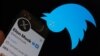 This illustration photo taken on July 24, 2023 shows the Twitter bird logo upside down in the background of Elon Musk’s screen advertising an "X" as a replacement logo, in Los Angeles.