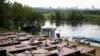 People rest at a one of parks by the Moscow River during a hot day in Moscow, Russia, June 9, 2020. 