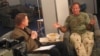 Then-American Forces Network reporter Kane Farabaugh interviews Robin Williams in Afghanistan in 2002.