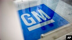 FILE - In this Thursday, Jan. 10, 2013 file photo, the logo for General Motors decorates the entrance to a former UPS facility as GM announced plans to open an information technology center in the building that would create about 1,000 jobs, in Roswell, G