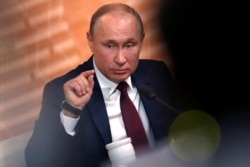 FILE - Russian President Vladimir Putin gestures during his annual end-of-year news conference in Moscow, Russia Dec. 19, 2019.