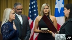 Justice Secretary Wanda Vazquez is sworn in as governor of Puerto Rico by Supreme Court Justice Maite Oronoz, in San Juan, Aug. 7, 2019. Vazquez was joined by her daughter Beatriz Diaz Vazquez and her husband Judge Jorge Diaz. 