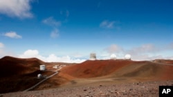 FILE - Observatories and telescopes sit atop Mauna Kea, Hawaii's tallest mountain and designated construction site for a new $1.4 billion telescope, near Hilo, Hawaii, Aug. 31, 2015. 