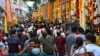 People make their way on a street to buy goods and decorative ornaments on the eve of the Hindu festival of Diwali in the Little India district in Singapore on November 3, 2021. (Photo by Roslan RAHMAN / AFP)