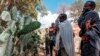 People mourn in front of a mass grave the victims of a massacre allegedly perpetrated by neighbouring Eritrean Soldiers in the village of Dengolat, North of Mekele, the capital of Tigray on February 26, 2021.