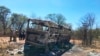 Emergency services stand near to a burned out bus after a bus accident in Gwanda about 550 kilometres south of the capital Harare, Nov. 16, 2018. Police in Zimbabwe say more than 40 people have been killed in a bus accident Thursday night.