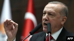 President of Turkey and leader of Justice and Development (AK) Party Recep Tayyip Erdogan speaks at the party's group meeting at Grand National Assembly of Turkey in Ankara, on February 12, 2020. (Photo by Adem ALTAN / AFP)