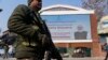 An Indian paramilitary soldier patrols near an electronic display in Srinagar, welcoming the Indian Prime Minister Narendra Modi to inaugurate a strategic tunnel project that connects Kashmir with Ladakh, Jan.13, 2025.