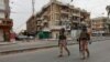 FILE - Iraqi security forces are seen on patrol in central Baghdad, Iraq, April 7, 2020. 