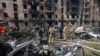 Emergency workers inspect a damaged multi-storey apartment building caused by the latest rocket Russian attack in Kryvyi Rih, Ukraine, Tuesday, June 13, 2023. 