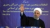 In this photo released by official website of the office of the Iranian Presidency, President Hassan Rouhani waves to media after casting his vote for parliamentary and Experts Assembly elections in Tehran, Iran Friday, Feb. 26, 2016.