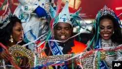 Carnival King Momo, Djeferson Mendes da Silva, second from left, holds the key to the city at a ceremony marking the official start of Carnival on Copacabana beach, Rio de Janeiro, Brazil, Jan. 12, 2020.