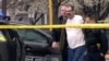 In this Sunday, April 13, 2014 image from video provided by KCTV-5, Frazier Glenn Cross, also known as Frazier Glenn Miller, is escorted by police in an elementary school parking lot in Overland Park, Kansas.