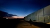 FILE - A man walks by the fence at the Pournara migrant reception center in Kokkinotrimithia outside of capital Nicosia, Cyprus, Jan. 24, 2024. 