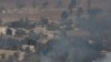 FILE - Smoke and fire rise in the Quneitra province as Syrian rebels clash with President Assad’s forces, as seen from the Israeli controlled-Golan Heights, Aug. 27, 2014. 