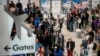 FILE PHOTO: Travelers wait at John F. Kennedy International Airport in New York