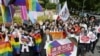 People including plaintiffs' lawyers hold banners and flags after the lower court ruled that not allowing same-sex marriage was unconstitutional outside Nagoya district court
